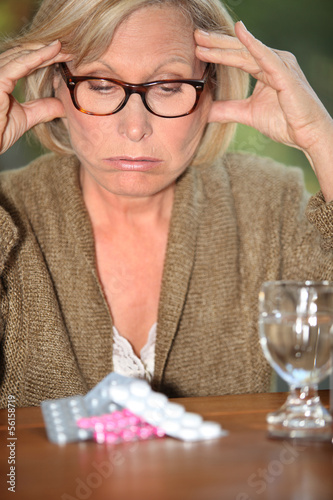 Photo: senior lady taking too much pills senior lady taking too much pills