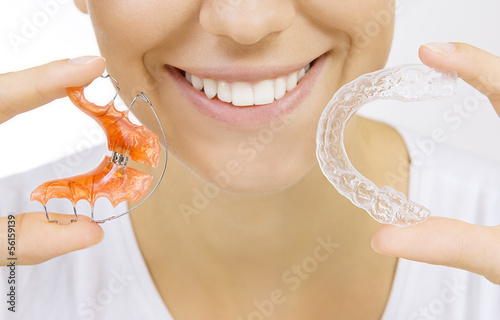 Photo: hands holding retainer for teeth and tooth tray hands holding retainer for teeth and tooth tray