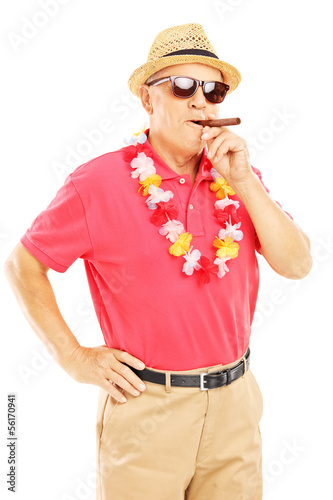 Photo: Mature gentleman with lei smoking a cigar and looking at camera Mature gentleman with lei smoking a cigar and looking at camera
