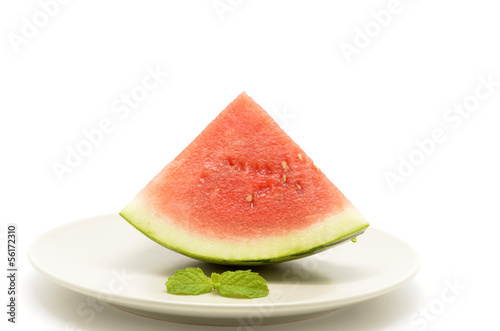 Photo: slice of watermelon with a triangle shaped on plate slice of watermelon with a triangle shaped on plate