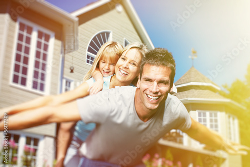 Photo: Happy family near the house Happy family near the house