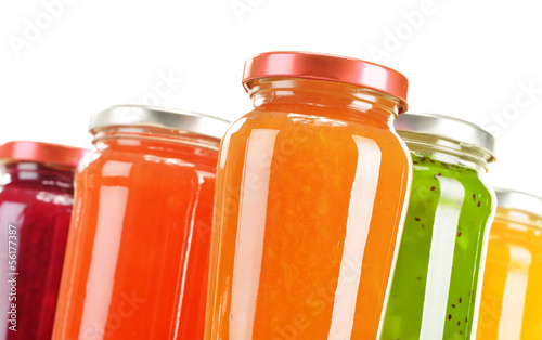 Photo: Jars of fruity jams isolated on white background Jars of fruity jams isolated on white background
