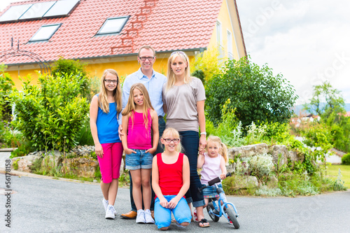 Photo: happy Family in front of their home happy Family in front of their home