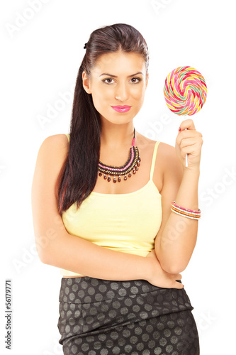 Photo: Beautiful female holding a lollipop and posing Beautiful female holding a lollipop and posing