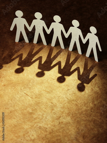 Photo: Group of paper people holding hands. Group of paper people holding hands.