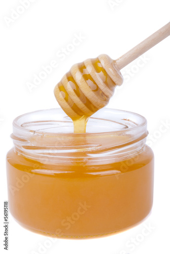 Photo: Honey dripping into a jar with a special spoon. Honey dripping into a jar with a special spoon.