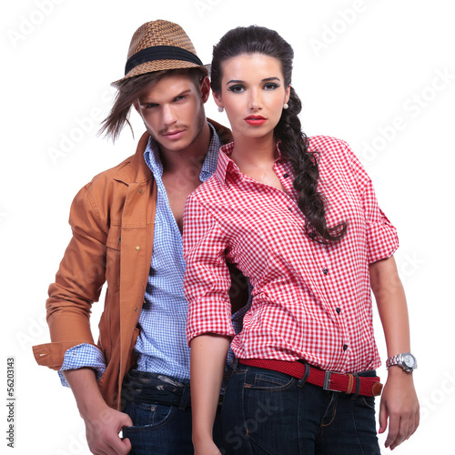 Photo: casual couple with man behind woman casual couple with man behind woman