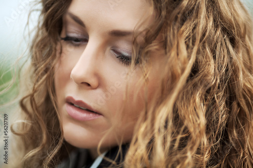 Photo: Sad beautiful woman looking down Sad beautiful woman looking down