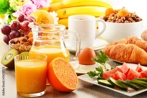 Photo: Breakfast with coffee, orange juice, croissant, egg, vegetables Breakfast with coffee, orange juice, croissant, egg, vegetables