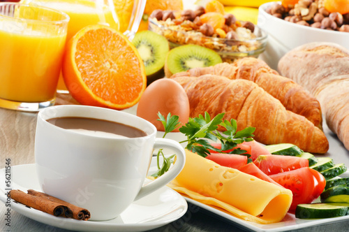 Photo: Breakfast with coffee, orange juice, croissant, egg, vegetables Breakfast with coffee, orange juice, croissant, egg, vegetables
