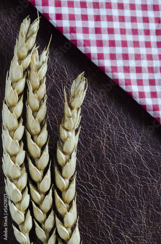 Photo: wheat and check napkin on leather wheat and check napkin on leather