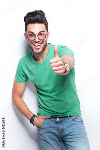Photo: casual man shows the thumbs up sign casual man shows the thumbs up sign