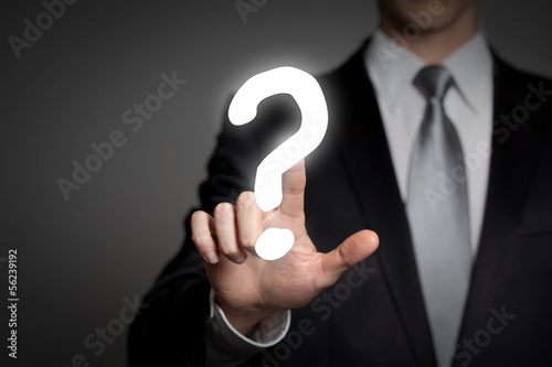 Photo: businessman pressing touchscreen questionmark - question businessman pressing touchscreen questionmark - question