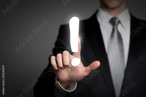 Photo: businessman pressing touchscreen exclamation mark businessman pressing touchscreen exclamation mark