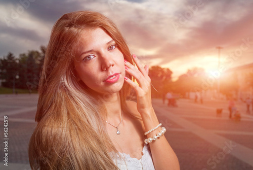 Photo: beautiful girl in the street at evening or night, sunset light beautiful girl in the street at evening or night, sunset light