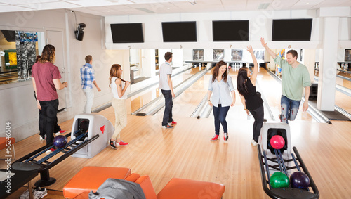 Photo: Friends Playing in Bowling Alley Friends Playing in Bowling Alley