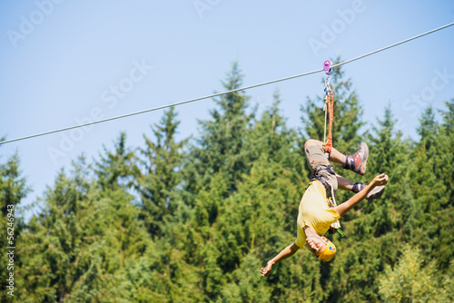 Photo: Man Hanging Upside Down On Zip Line Man Hanging Upside Down On Zip Line