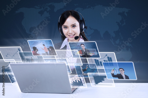 Photo: Businesswoman with digital photos on blue Businesswoman with digital photos on blue