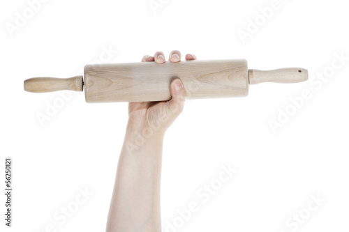 Photo: Female hand with wooden rolling pin Female hand with wooden rolling pin