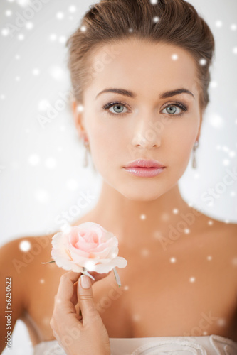 Photo: young woman with rose flower young woman with rose flower