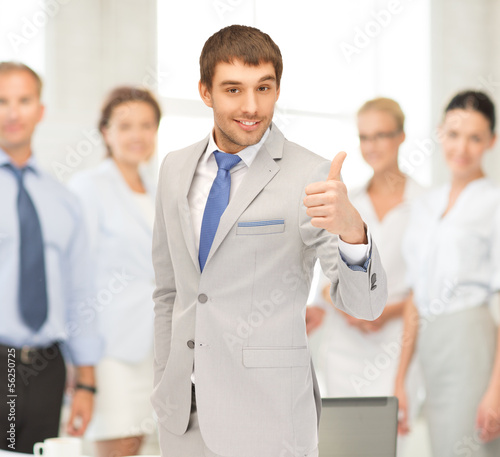 Photo: smiling businessman with thumbs up smiling businessman with thumbs up