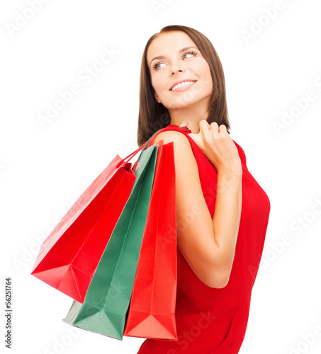 Photo: woman in red dress with shopping bags woman in red dress with shopping bags