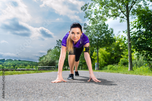 Photo: Sports outdoor - young woman doing fitness in park Sports outdoor - young woman doing fitness in park