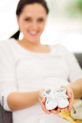 Photo: mother to be holding baby shoes mother to be holding baby shoes