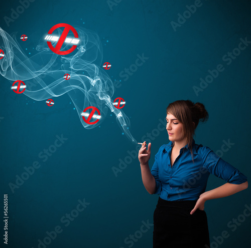 Photo: Young woman smoking dangerous cigarette with no smoking signs Young woman smoking dangerous cigarette with no smoking signs