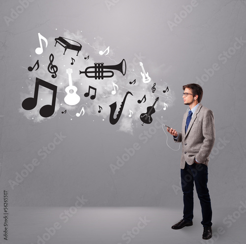 Photo: attractive young man singing and listening to music with musical attractive young man singing and listening to music with musical