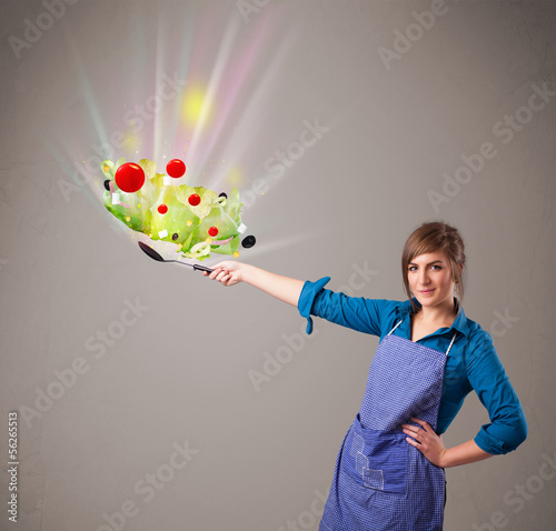Photo: Young woman cooking fresh vegetables Young woman cooking fresh vegetables