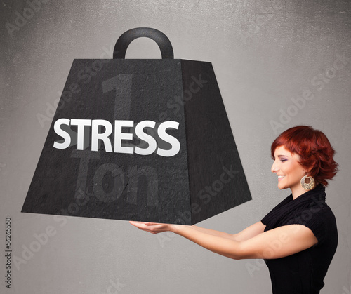 Photo: Young woman holding one ton of stress weight Young woman holding one ton of stress weight
