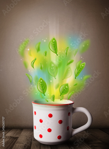 Photo: Tea cup with leaves and colorful abstract lights Tea cup with leaves and colorful abstract lights