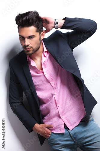 Photo: young fashion man scrathes his head young fashion man scrathes his head