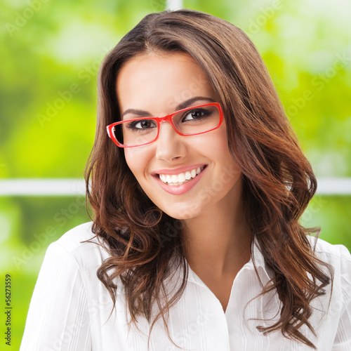 Photo: Young smiling businesswoman at office Young smiling businesswoman at office