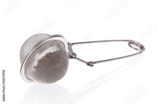 Photo: Tea infuser with Green Tea leaves isolated on a white background Tea infuser with Green Tea leaves isolated on a white background