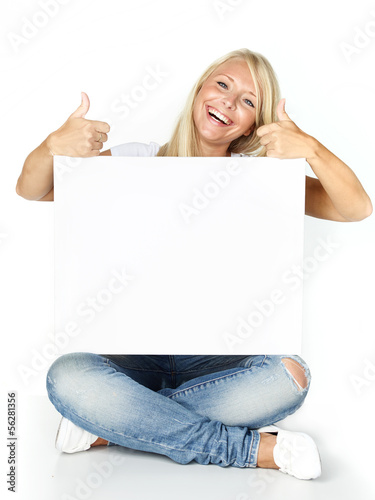 Photo: Smiling woman with message board shows thumbs up Smiling woman with message board shows thumbs up
