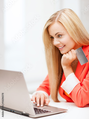 Photo: businesswoman with laptop using credit card businesswoman with laptop using credit card