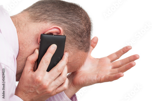 Photo: Frustrated man talking on the phone Frustrated man talking on the phone