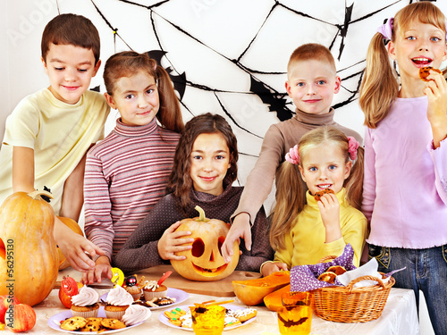 Photo: Halloween party with children holding trick or treat. Halloween party with children holding trick or treat.