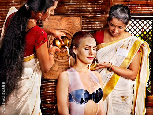 Photo: Woman having Ayurvedic spa treatment. Woman having Ayurvedic spa treatment.