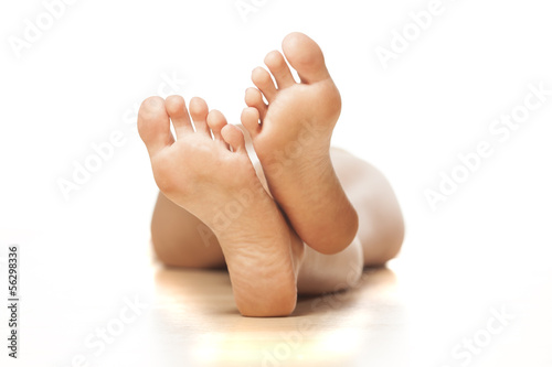 Photo: naked woman lying on the floor with a focus on feet naked woman lying on the floor with a focus on feet