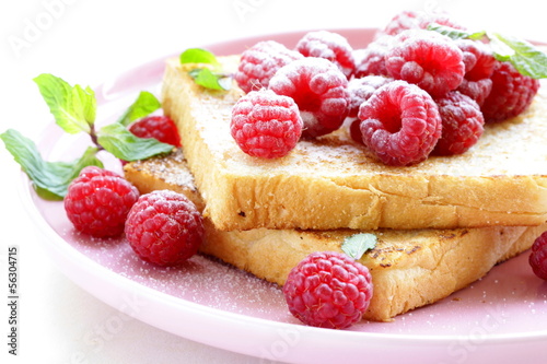 Photo: fresh toasted toast with raspberries and powdered sugar fresh toasted toast with raspberries and powdered sugar