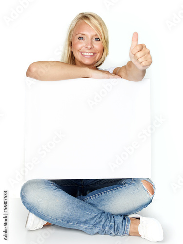 Photo: Woman with message board shows thumb up Woman with message board shows thumb up