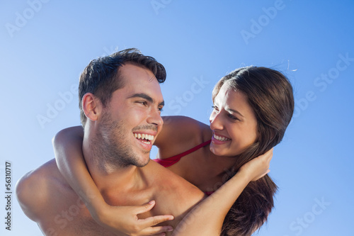 Photo: Handsome man carrying his girlfriend on his back Handsome man carrying his girlfriend on his back
