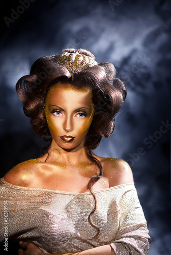 Photo: Coloring. Portrait of Styled Woman with Golden Colored Skin Coloring. Portrait of Styled Woman with Golden Colored Skin