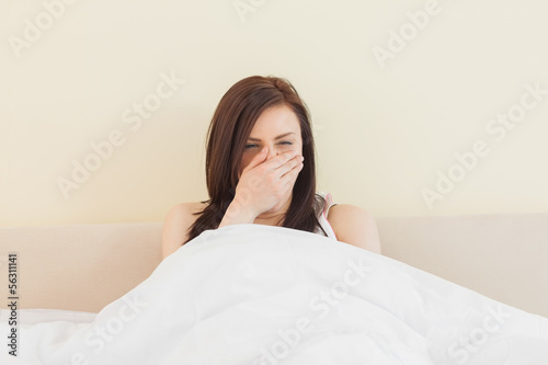 Photo: Awakened girl yawning in her bed Awakened girl yawning in her bed