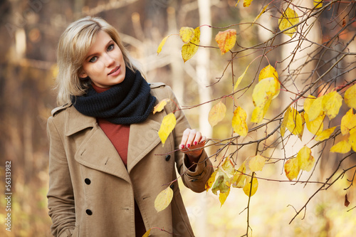 Photo: Happy blond woman in autumn forest Happy blond woman in autumn forest