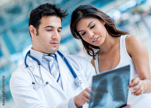 Photo: Doctor checking x-ray of a patient Doctor checking x-ray of a patient