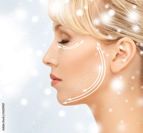Photo: beautiful young woman face with arrows beautiful young woman face with arrows